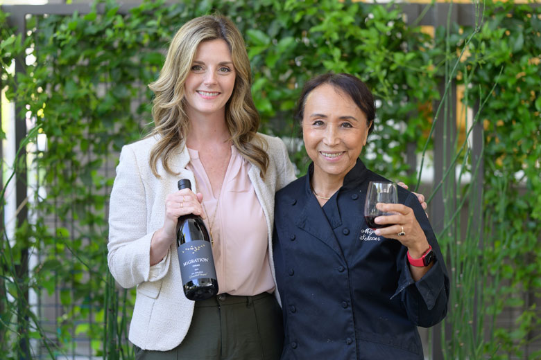 Dana Epperson and Chef Miyoko Schinner holding a bottle of Migration Pinot Noir