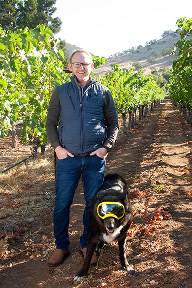 Cardiff with his dog Lando in the vineyard