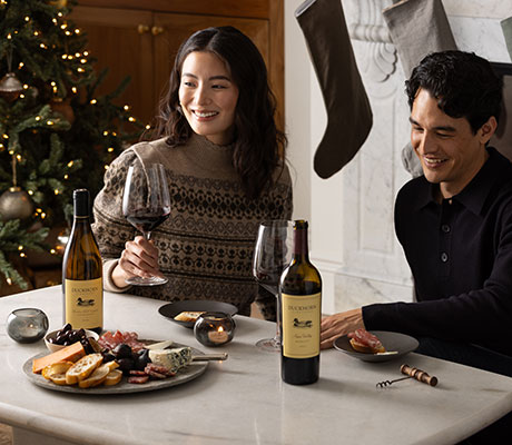 Duckhorn Vineyards wines on a coffee table with two people