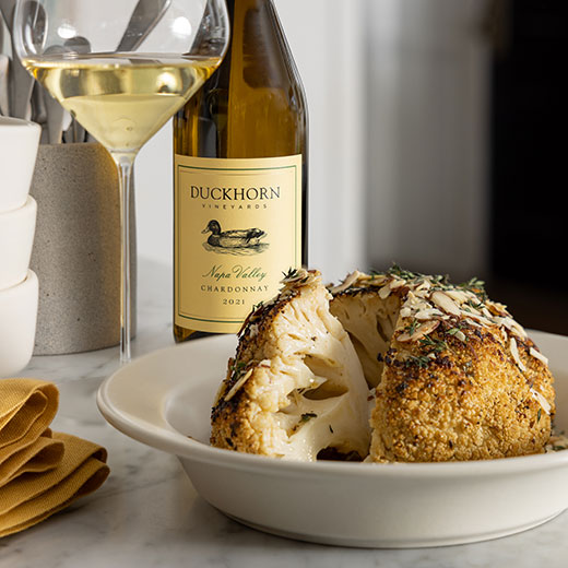 Whole Roasted Cauliflower with Garlic Herb Butter and Toasted Almonds