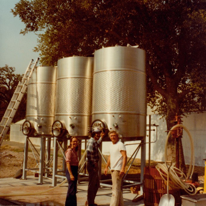 Dan and Margaret Duckhorn with Tom Rinaldi in front of tanks