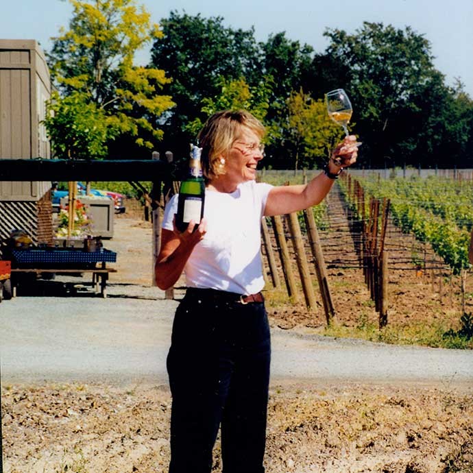 Margaret Duckhorn raising a glass upon building Duckhorn Estate house