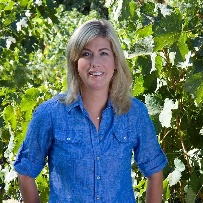 Winemaker Renee Ary standing in vineyards