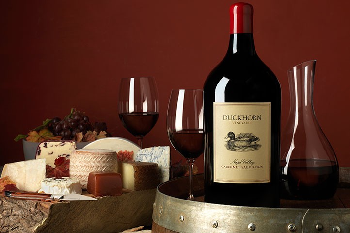 Large format wine bottle on a barrel with decanter