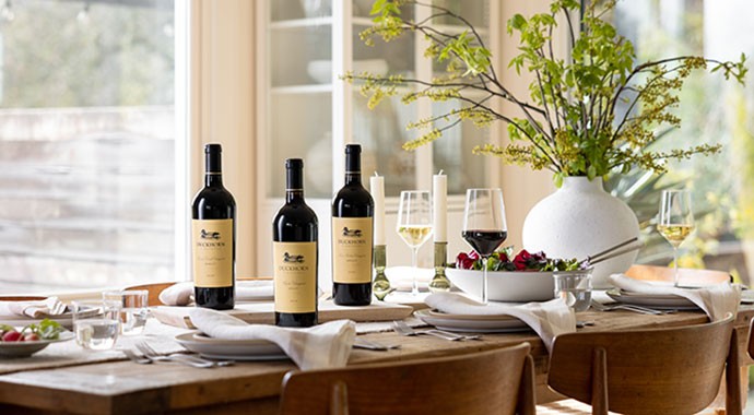 Duckhorn Vineyards wines on a table with plates