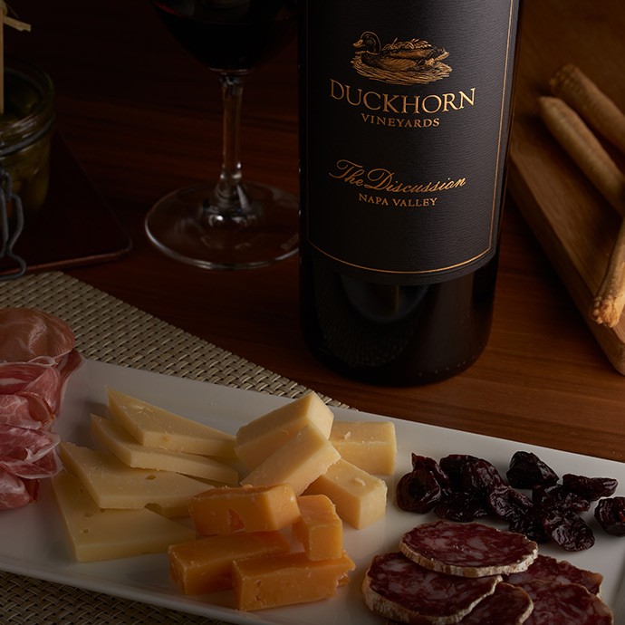 Bottle of Discussion with charcuterie