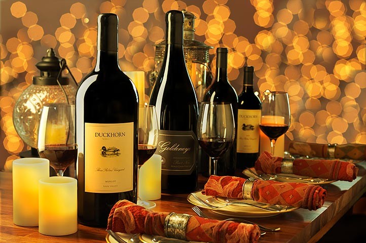 Large format wine bottles at dusk on dining table